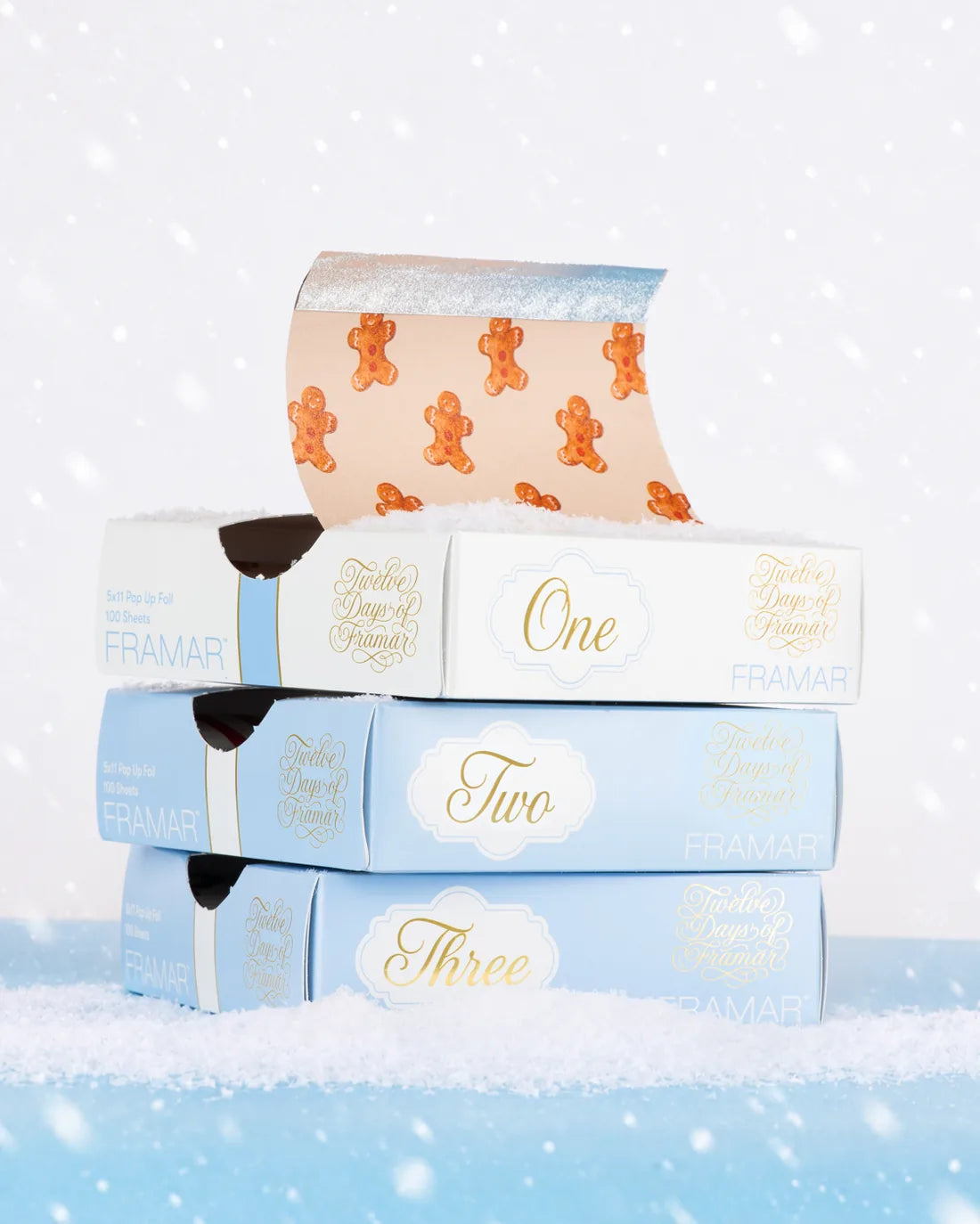 Three numbered blue Advent drawers stacked in the snow